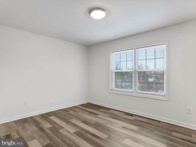 empty room with hardwood / wood-style floors