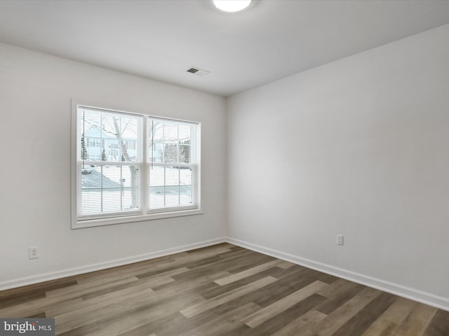 unfurnished room with hardwood / wood-style floors