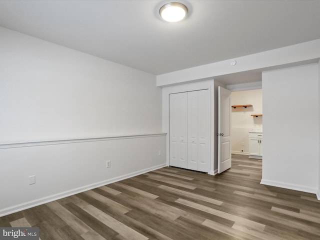 unfurnished bedroom featuring dark hardwood / wood-style floors and a closet