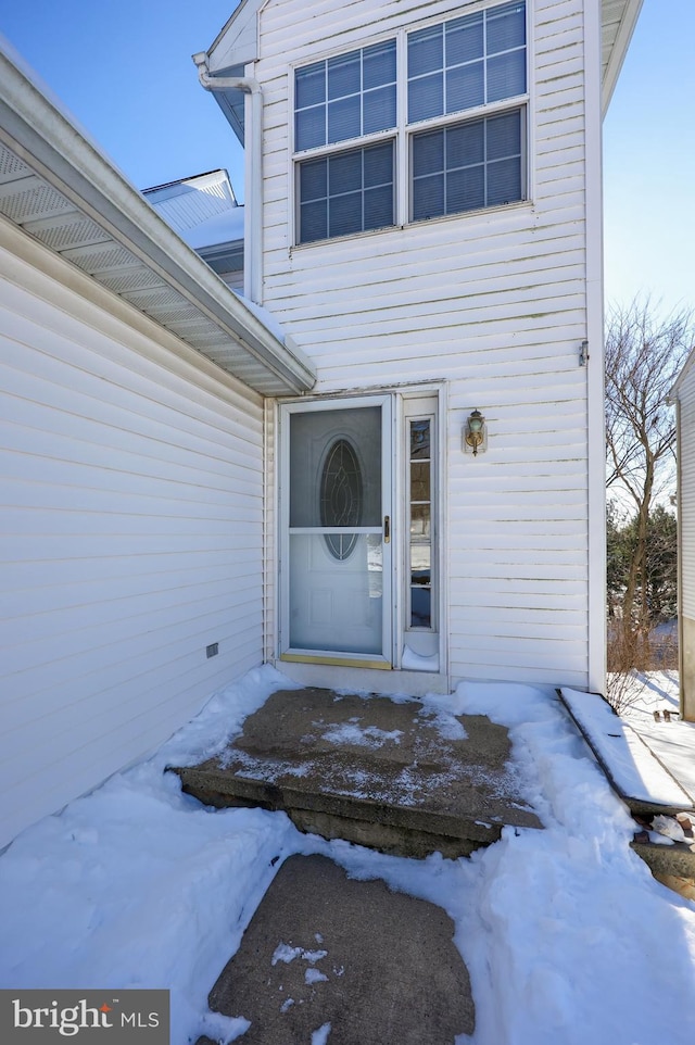 view of snow covered property entrance