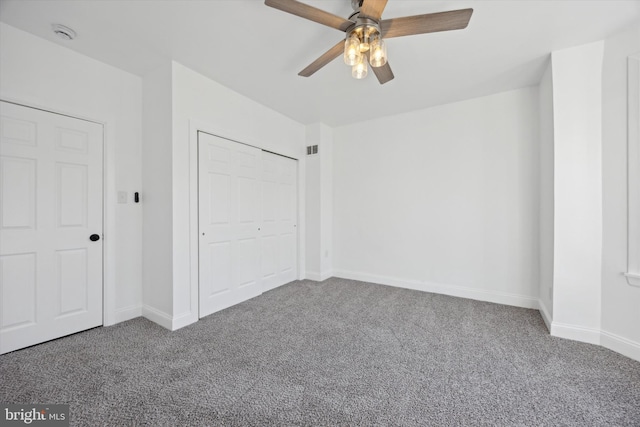 unfurnished bedroom with carpet flooring, ceiling fan, and a closet