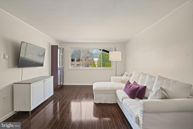 living room featuring dark hardwood / wood-style flooring and ornamental molding