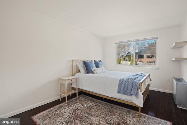 bedroom with dark hardwood / wood-style floors