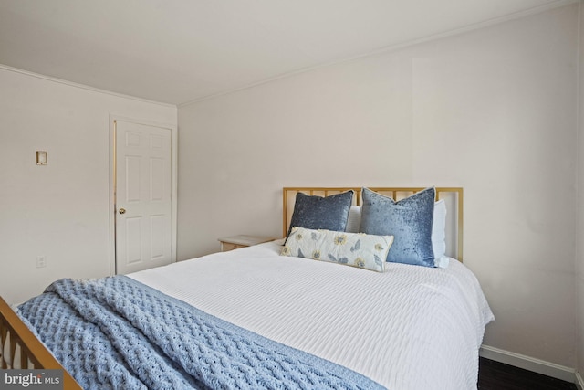 bedroom with dark hardwood / wood-style floors