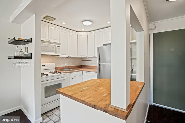 kitchen with butcher block countertops, white cabinetry, sink, crown molding, and white appliances