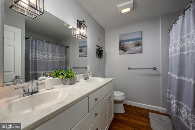 bathroom featuring hardwood / wood-style flooring, toilet, vanity, and a shower with shower curtain