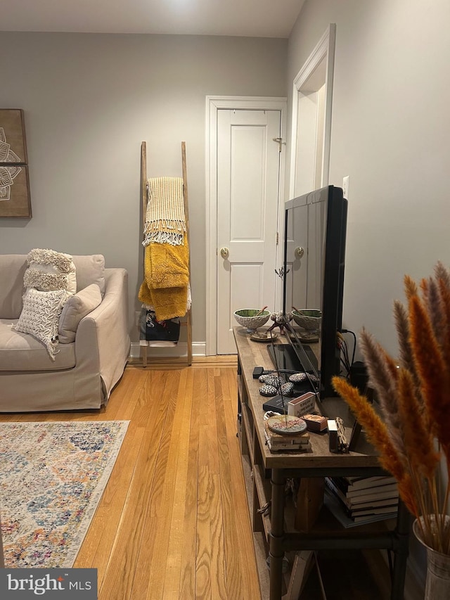 home office with light hardwood / wood-style flooring