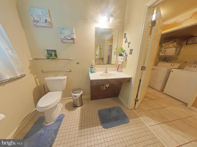 bathroom featuring sink, tile patterned floors, washer and dryer, and toilet