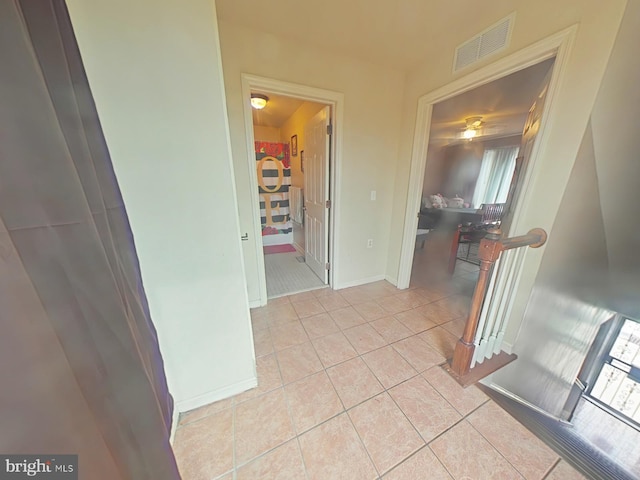 corridor with light tile patterned flooring