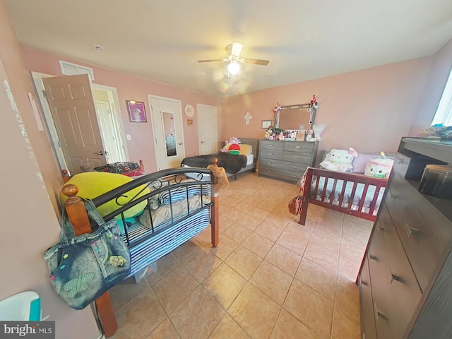 bedroom with light tile patterned flooring and ceiling fan