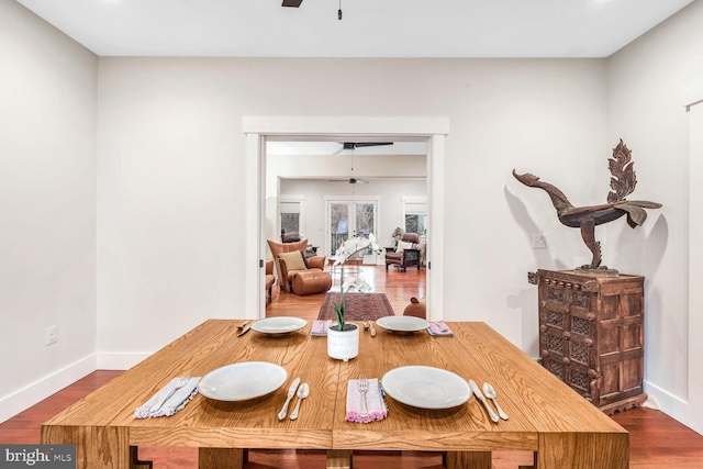 dining area with hardwood / wood-style flooring and ceiling fan