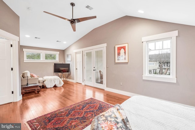 bedroom with vaulted ceiling, ceiling fan, light hardwood / wood-style floors, and french doors