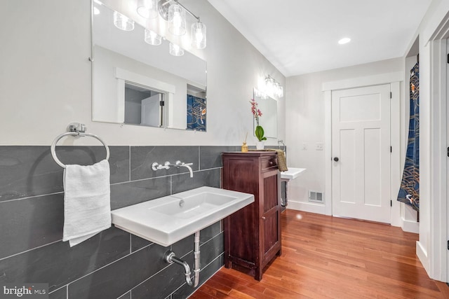 bathroom featuring decorative backsplash and wood-type flooring