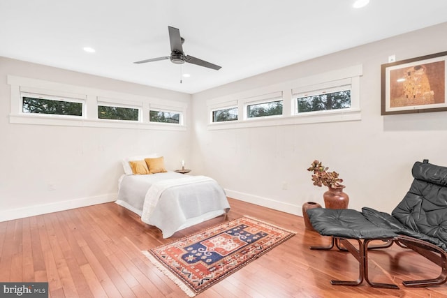 bedroom with wood-type flooring and ceiling fan