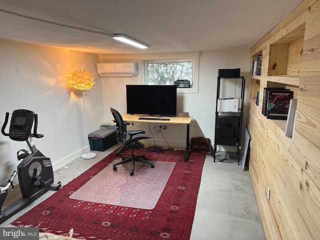 office with a wall mounted air conditioner and concrete floors