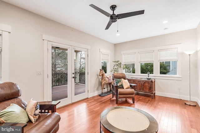 living area featuring a wealth of natural light, light hardwood / wood-style floors, and french doors