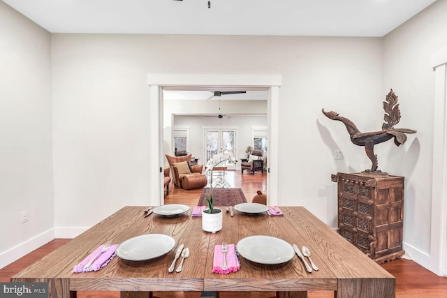 dining area with wood-type flooring and french doors