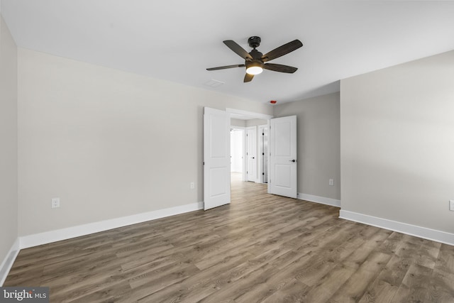 unfurnished bedroom featuring ceiling fan and hardwood / wood-style floors