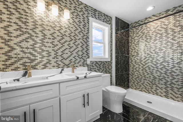 bathroom featuring toilet, vanity, tile walls, and tiled shower