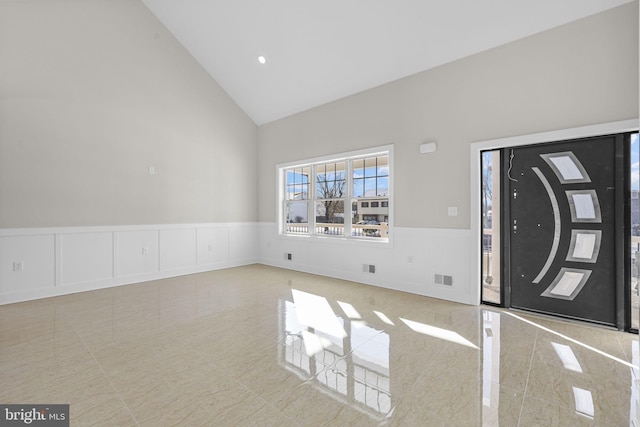 entrance foyer featuring high vaulted ceiling