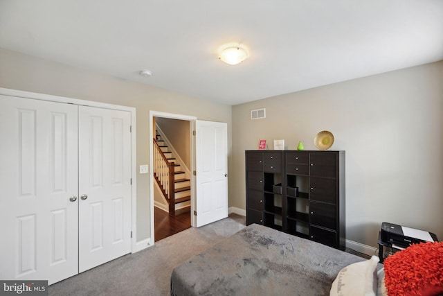 carpeted bedroom with a closet