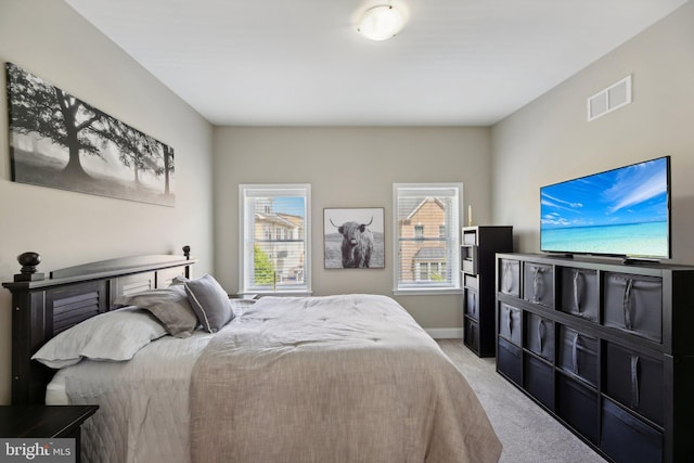 bedroom featuring light carpet