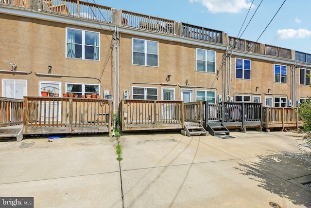 back of house featuring a patio area and a wooden deck