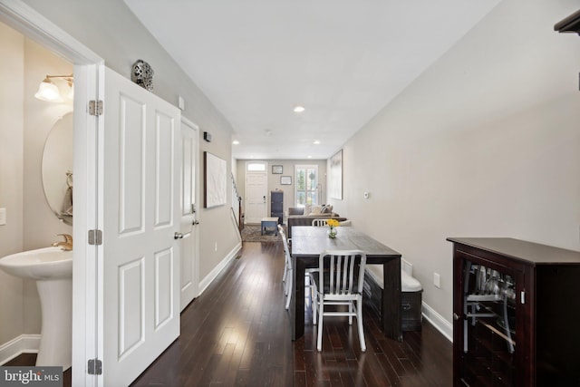 dining area with wine cooler, dark wood-type flooring, and sink