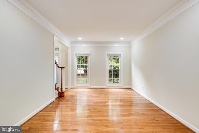 unfurnished room with crown molding and light hardwood / wood-style flooring