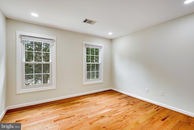 spare room featuring light hardwood / wood-style flooring