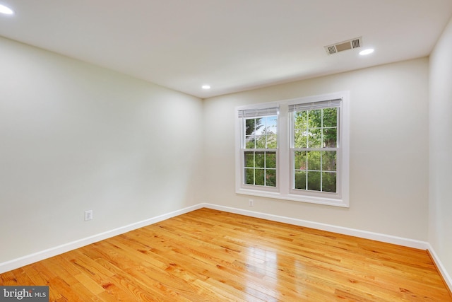 unfurnished room with light hardwood / wood-style floors