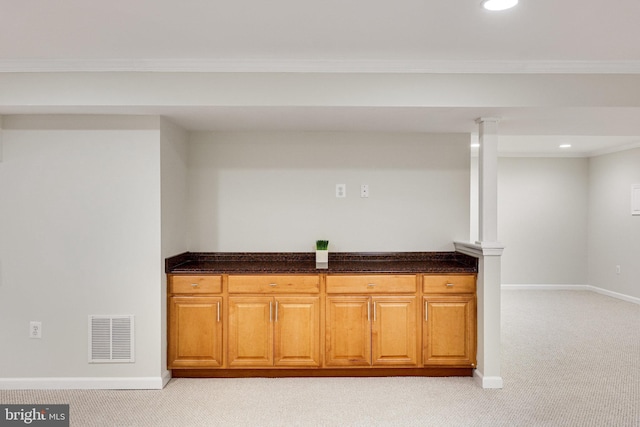 bar with crown molding and light carpet