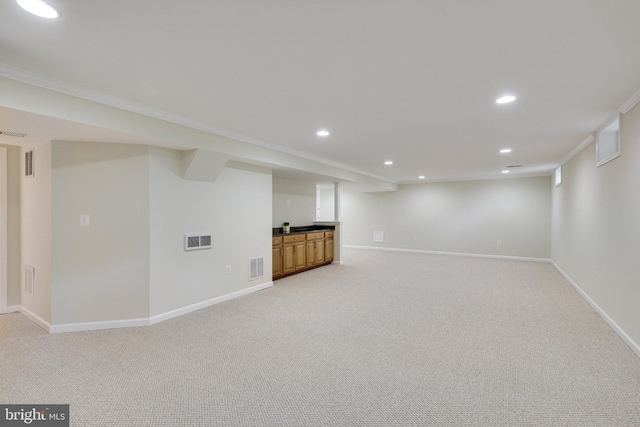 basement featuring ornamental molding and light carpet