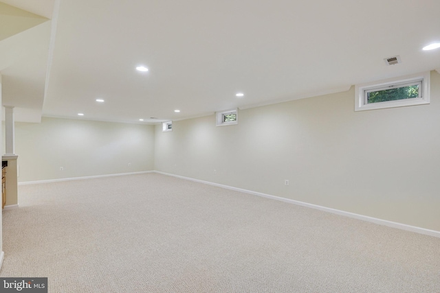 basement featuring light colored carpet