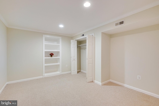 unfurnished bedroom with a closet, crown molding, and light colored carpet