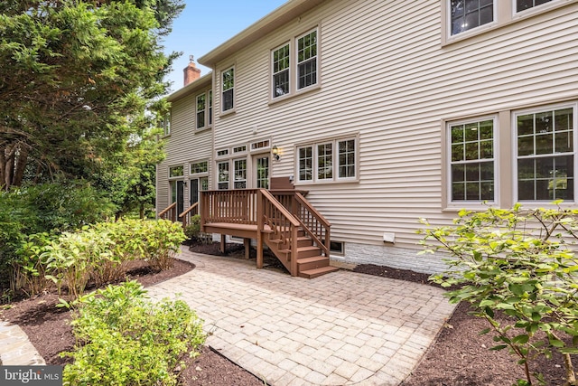 rear view of house featuring a deck and a patio area