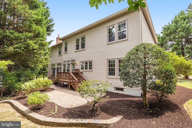 rear view of property featuring a deck and a patio