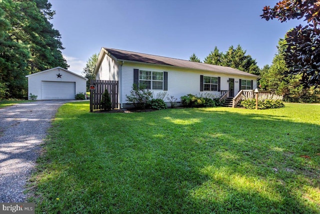 ranch-style home featuring a garage, a front lawn, an outbuilding, and a wooden deck