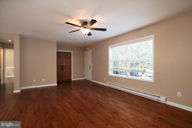 spare room featuring a baseboard heating unit, ceiling fan, and dark hardwood / wood-style flooring