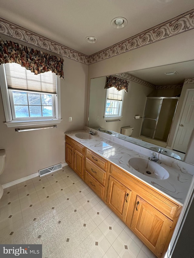 bathroom featuring walk in shower, vanity, and toilet