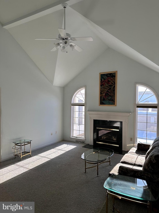 unfurnished living room featuring carpet floors, high vaulted ceiling, a premium fireplace, and ceiling fan