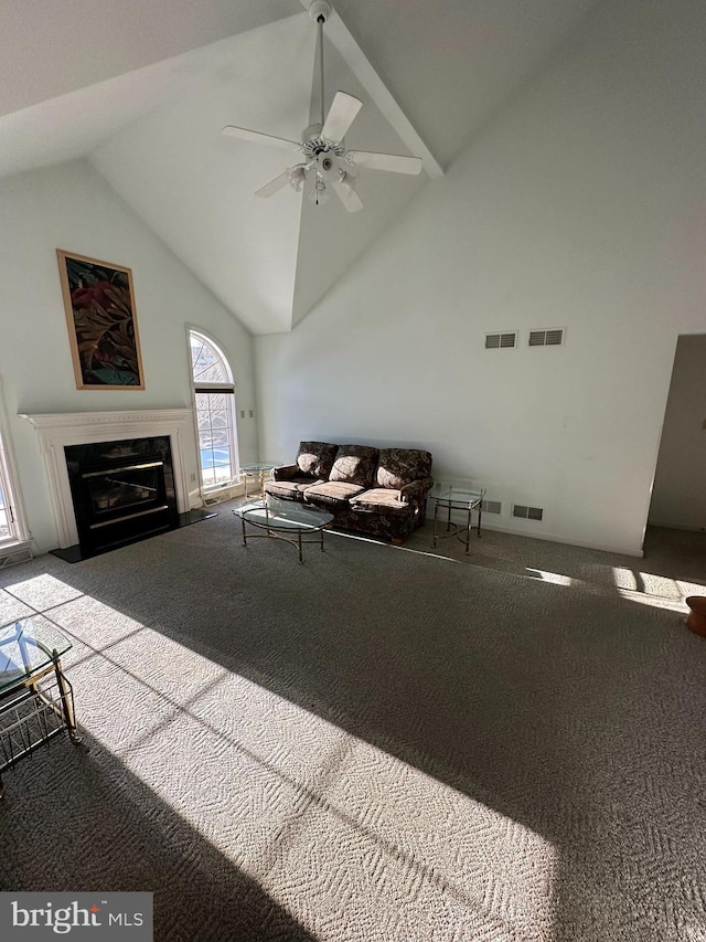 unfurnished living room with ceiling fan, high vaulted ceiling, a premium fireplace, and carpet floors