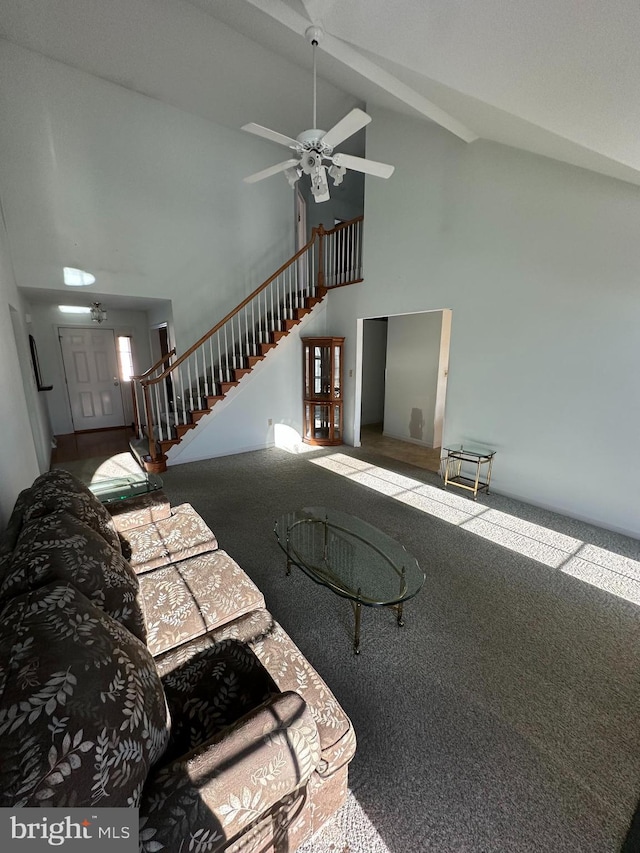 unfurnished living room with carpet floors and high vaulted ceiling