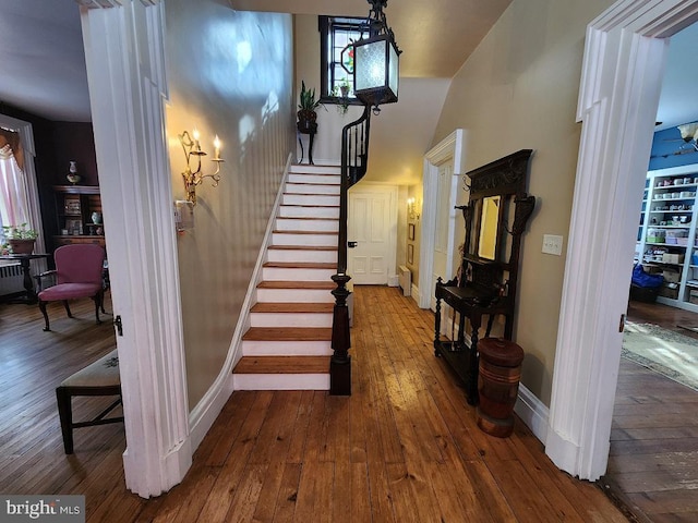 stairway with hardwood / wood-style flooring