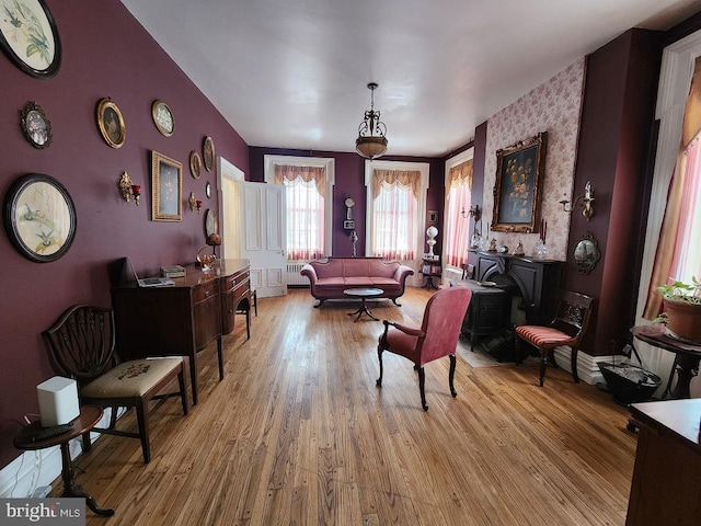 living area featuring radiator heating unit and light hardwood / wood-style floors