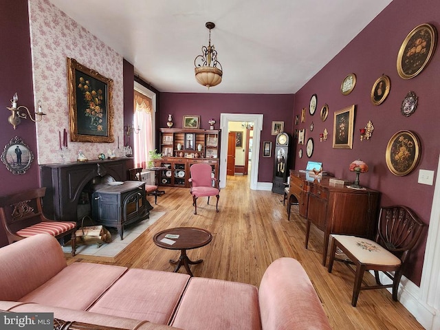 interior space with light hardwood / wood-style floors and a wood stove