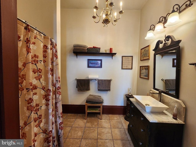 bathroom with tile patterned floors, vanity, a notable chandelier, and walk in shower