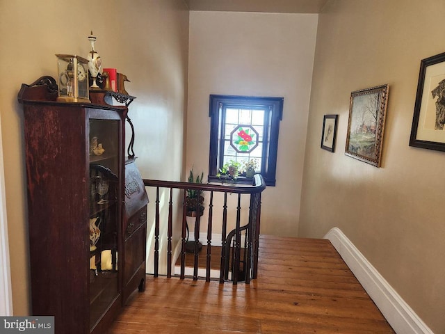 corridor featuring hardwood / wood-style floors