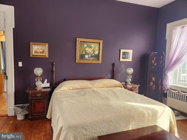 bedroom featuring radiator and wood-type flooring