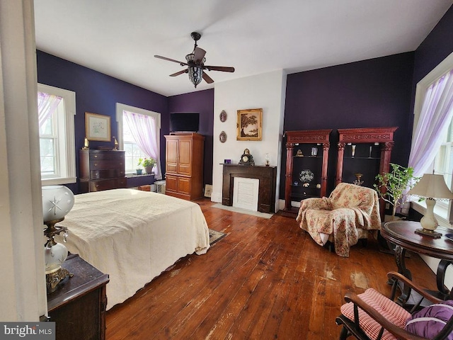 bedroom with ceiling fan and dark hardwood / wood-style floors